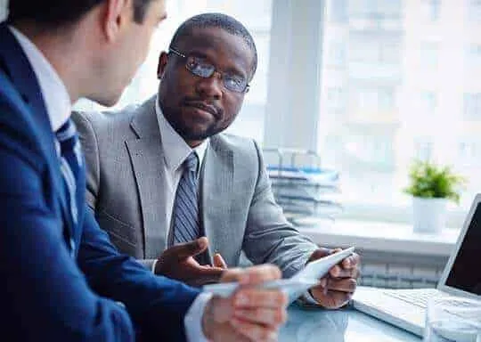 Two professionals reviewing documents together